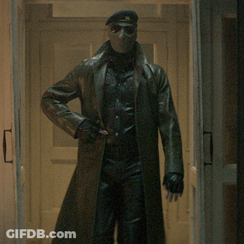 Man In Mask And Sunglasses Walking Through Hallway GIF