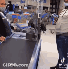 Man In Mask At Grocery Checkout Counter GIF