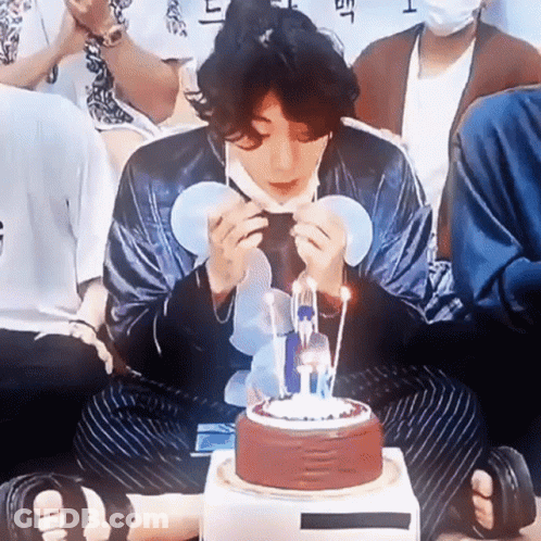Man In Mask Blowing Out Birthday Candles GIF