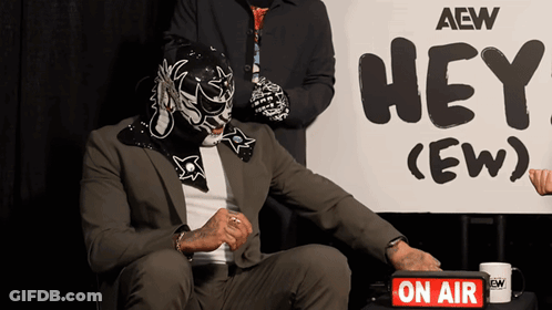 Man In Mask By Sign Saying Hey (Ew) GIF