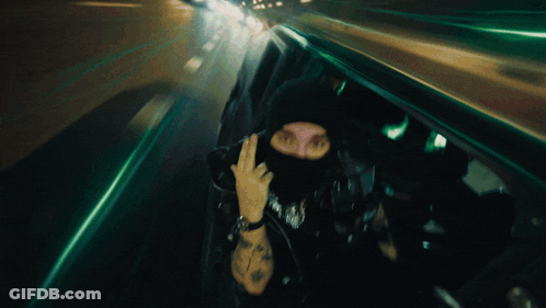Man In Mask Giving Middle Finger Blurry Photo GIF