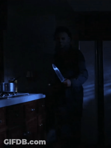 Man In Mask Holding Large Knife GIF