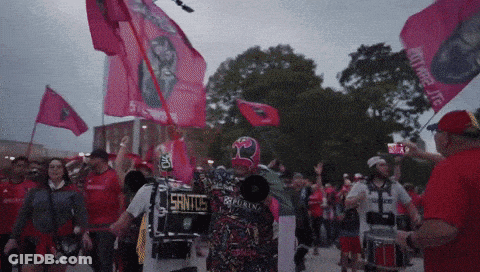Man In Mask Holding Megaphone Saying Santos GIF