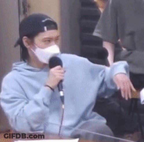 Man In Mask Holding Microphone GIF