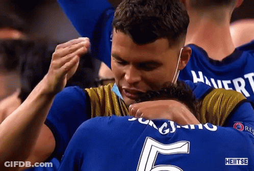 Man In Mask Hugging Man With Number 5 Jersey GIF
