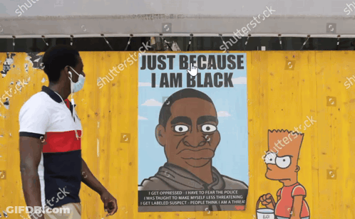 Man In Mask In Front Of Bart Simpson Poster Saying Just Because I Am Black GIF