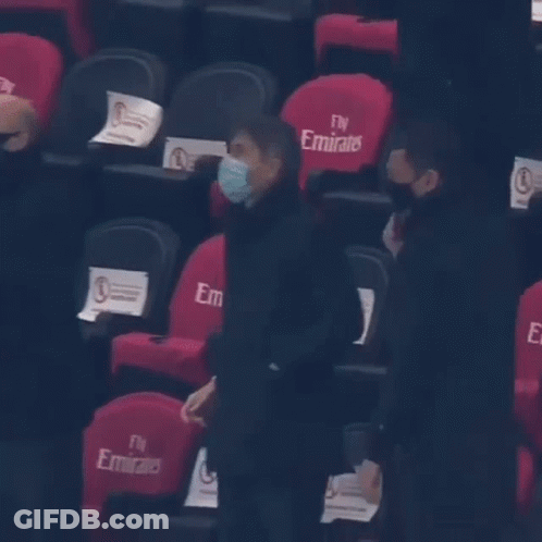 Man In Mask In Front Of Fly Emirates Chairs GIF