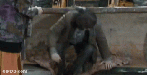 Man In Mask Kneeling With Woman Behind GIF
