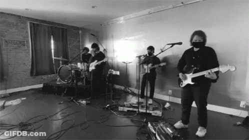 Man In Mask Playing Guitar At Microphone GIF