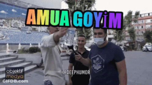 Man In Mask Pointing At Sign Saying Amua Goyim GIF