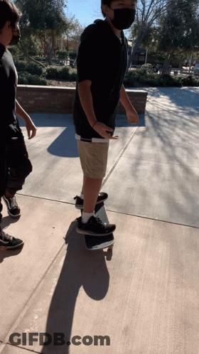 Man In Mask Riding Skateboard GIF