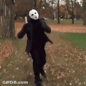 Man In Mask Running In Park GIF