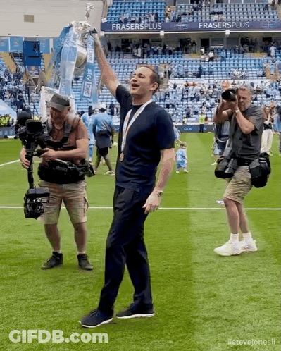 Man In Mask Shaking Hands In Front Of Audi Seats GIF