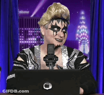 Man In Mask Sitting At Laptop With Microphone GIF