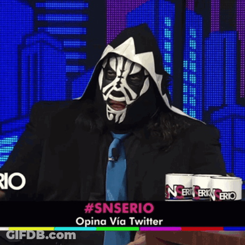 Man In Mask Sitting In Front Of #Snserio Sign GIF