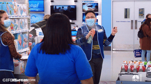 Man In Mask Spraying Woman In Store GIF