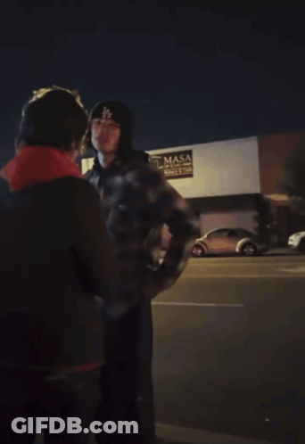 Man In Mask Standing Before Masa Building GIF