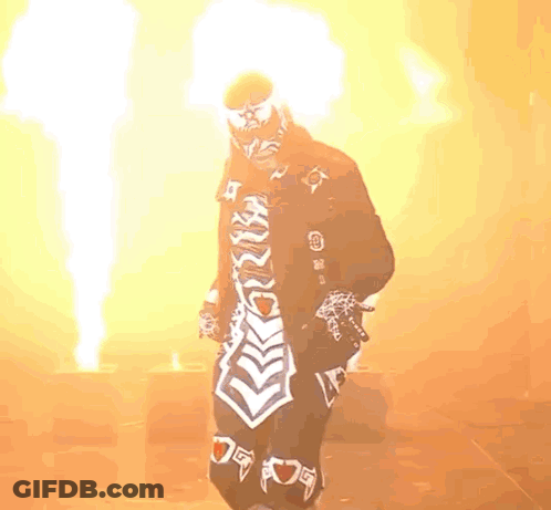 Man In Mask Standing By Ground Fire GIF