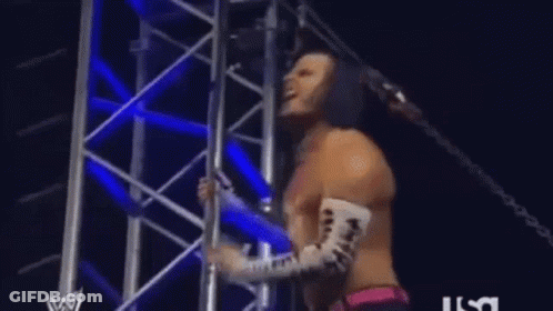Man In Mask Standing In Front Of AEW Screen GIF