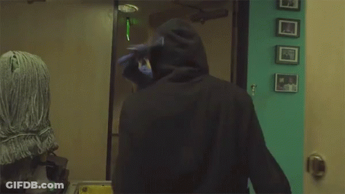Man In Mask Standing In Front Of Door GIF