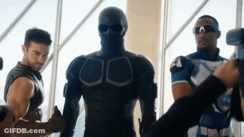 Man In Mask Standing Next To Two Men GIF