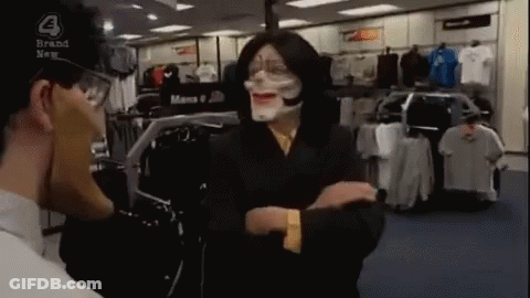 Man In Mask Talking To Another In Clothing Store GIF