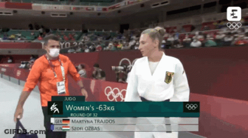 Man In Mask Talking To Woman In White Uniform GIF