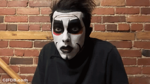 Man In Mask With A Standing Next To Man In Cape GIF