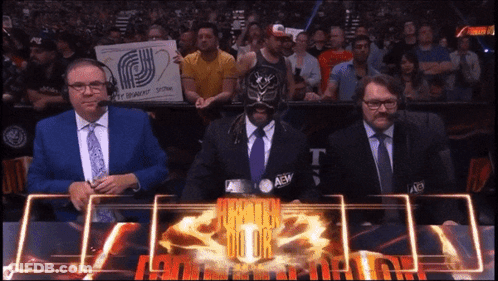 Man In Mask With AEW Logo On Jacket GIF
