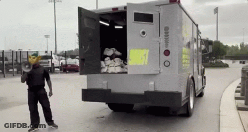 Man In Mask With Megaphone In Front Of Truck GIF