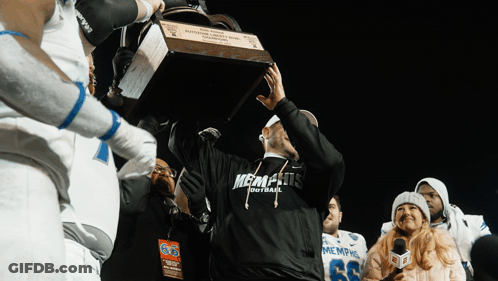 Man In Memphis Football Shirt Holding Trophy GIF