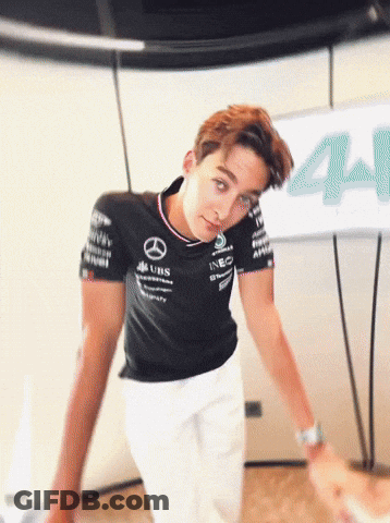 Man In Mercedes Shirt Beside Sign 44 GIF
