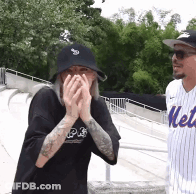 Man In Mets Jersey And Woman Covering Face GIF