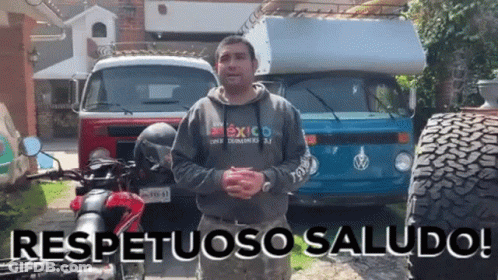 Man In Mexico Sweatshirt In Front Of Vehicles GIF
