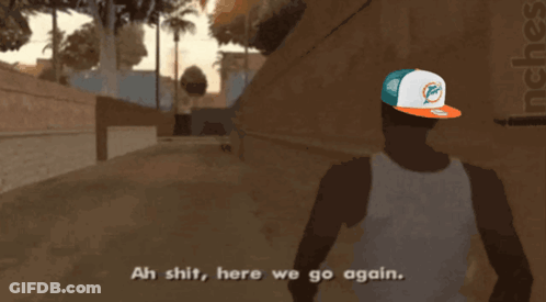 Man In Miami Dolphins Hat Walking Down Street GIF