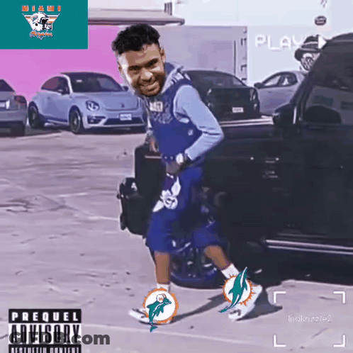 Man In Miami Dolphins Jersey Standing In Parking Lot GIF