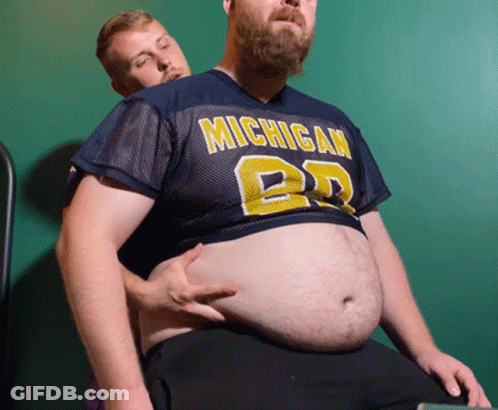 Man In Michigan Jersey Holding Another Man's Stomach GIF