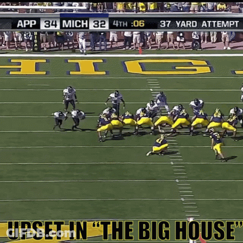 Man In Michigan Shirt Holding Head In Hands GIF