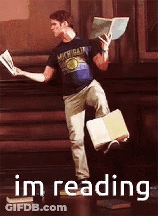 Man In Michigan Shirt Reading Book GIF