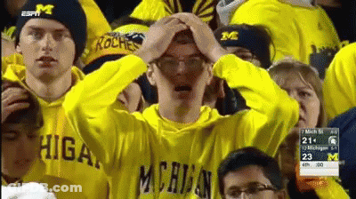 Man In Michigan Sweatshirt Holding Head GIF