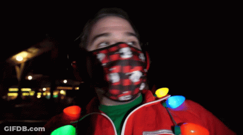 Man In Mickey Mouse Mask Holding Christmas Lights GIF