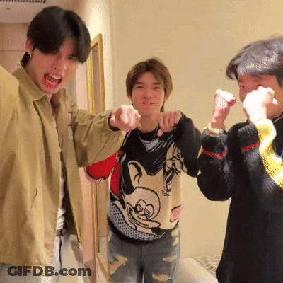 Man In Mickey Mouse Sweater Pointing GIF