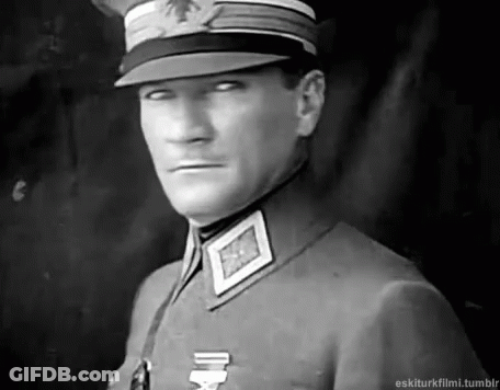 Man In Military Uniform And Hat Looking At Camera GIF