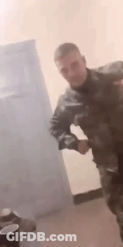 Man In Military Uniform Dancing With Gun GIF