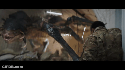 Man In Military Uniform Facing Crawling Monster GIF