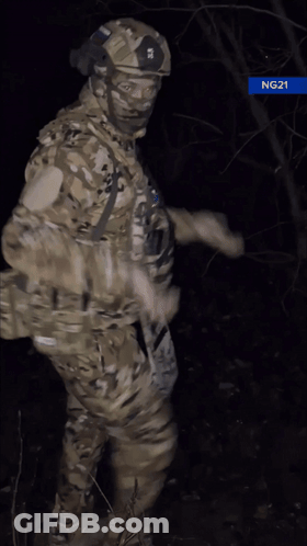 Man In Military Uniform Giving Thumbs Up In Dark GIF