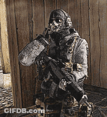 Man In Military Uniform Holding Gun GIF