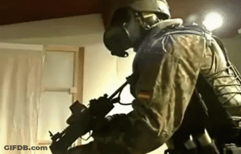 Man In Military Uniform Holding Gun GIF