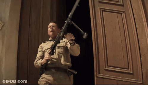Man In Military Uniform Holding Gun GIF