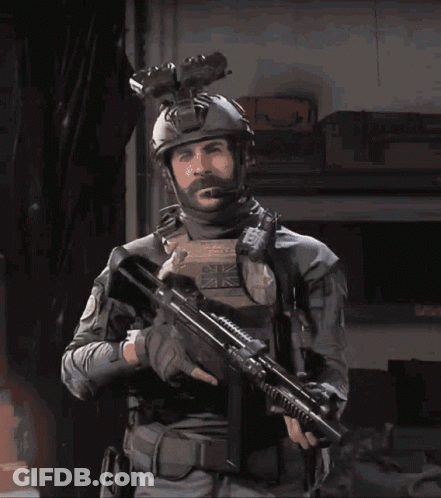 Man In Military Uniform Holding Gun With British Flag Patch GIF